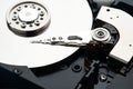 Closeup macro photo of head in opened hard disk drive. Concept of repair or recovery information from broken HDD. Royalty Free Stock Photo