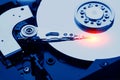 Closeup macro photo of head in opened hard disk drive. Concept of repair or recovery information from broken HDD. Royalty Free Stock Photo