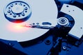 Closeup macro photo of head in opened hard disk drive. Concept of repair or recovery information from broken HDD. Royalty Free Stock Photo