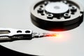Closeup macro photo of head in opened hard disk drive. Concept of repair or recovery information from broken HDD. Royalty Free Stock Photo