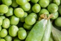 Closeup macro pile of fresh green peas ready for cleaning