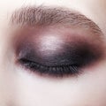 Closeup macro portrait of closed human female eye. Girl with perfect violet - black smoky eyes make-up Royalty Free Stock Photo