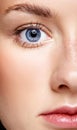 Closeup macro portrait of female face and blue eye. Human woman Royalty Free Stock Photo