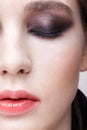 Closeup macro portrait of female face. Girl with perfect skin and violet - black smoky eyes make-up