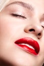 Closeup macro portrait of female face with red smiling lips and beauty makeup Royalty Free Stock Photo