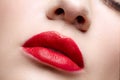 Closeup macro portrait of female red lips with day beauty makeup. Girl with perfect lips shape Royalty Free Stock Photo