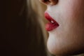 Closeup macro portrait of female red lips, part of face. woman lips with day beauty makeup.