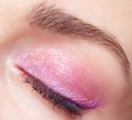 Closeup macro shot of closed human female eye. Woman with perfect skin and pink eyes shadows Royalty Free Stock Photo