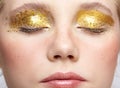 Closeup macro shot of closed human female face with yellow smoky eyes beauty makeup
