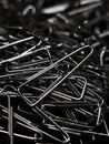 a large pile of triangular shaped shiny silver paper clips