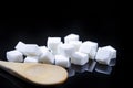 Closeup Macro Shot of White Cube Sugar Placed Bulk Along With Wooden Spoon. Against Black Background Royalty Free Stock Photo