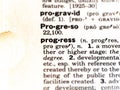 Closeup of the dictionary definition of the word progress Royalty Free Stock Photo