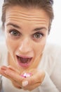 Closeup on mad woman eating handful of pills