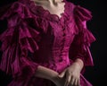 A closeup of a magenta corset dress with ruffled sleeves and lace accents. Trendy color of 2023 Viva Magenta.. AI