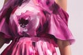 A closeup of a magenta dress with offtheshoulder sleeves and a flared skirt. Trendy color of 2023 Viva Magenta.. AI Royalty Free Stock Photo