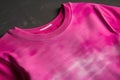 A closeup of a magenta Tshirt with a large logo printed on the front. Trendy color of 2023 Viva Magenta.. AI generation