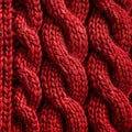 Closeup of a magenta woolen sweater with a braided pattern