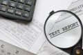 Closeup of magnifying glass on test report Royalty Free Stock Photo