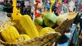A closeup of Maize and large green mango on dispplay. Royalty Free Stock Photo