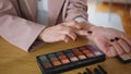 Closeup makeup artist hands applying cosmetics swatches testing. Woman visage