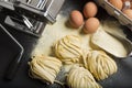 Fresh homemade pasta with pasta ingredients and pasta machine on the dark background Royalty Free Stock Photo