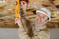 closeup male carpenter using level on wood structure Royalty Free Stock Photo