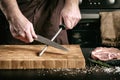 Closeup of male chef hands sharpen a big chef`s knife Royalty Free Stock Photo