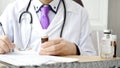 Closeup of male doctor hand writing a medical prescription Royalty Free Stock Photo