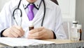 Closeup of male doctor hand writing a medical prescription Royalty Free Stock Photo