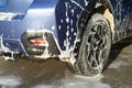 Closeup of male driver washing his car with contactless high pressure water jet in self service car wash Royalty Free Stock Photo