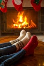 Closeup of male and female feet in woolen socks warming at burning fireplace Royalty Free Stock Photo