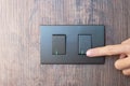Closeup Male finger is turn on or off on light switch on wall at home. Energy Saving, power, electrical and lifestyle concepts Royalty Free Stock Photo