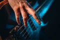 Closeup of male fingers playing 5 stringed electric bass guitar Royalty Free Stock Photo