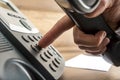 Closeup of male hand dialing a telephone number on black landlin Royalty Free Stock Photo