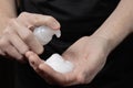 Closeup of male hand with foam on palm. man squeezes shaving foam ontohand. Putting whip soap bottle with foam on hand