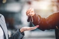 Closeup male hand giving a car key for vehicle loan credit financial, lease or rental concept Royalty Free Stock Photo