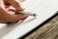 Closeup of male hand holding an ink pen pointing with its end on Royalty Free Stock Photo