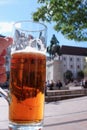 Closeup of a male hand holding up a glass of beer