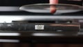 Closeup of Male Hand Inserts DVD Disk into Player