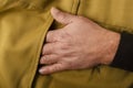 Closeup of male hand and pocket of classic brown pants