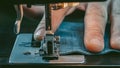 Closeup Male Hand Sewing Denim On A Sewing Machine. Worker Clothes. Macro Shooting. Sewing Still Life. High Quality Photo