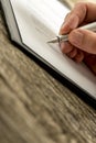 Closeup of male hand signing business contract, subscription for Royalty Free Stock Photo