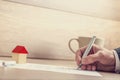 Closeup of male hand signing insurance papers, contract of house Royalty Free Stock Photo