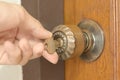 Closeup of male hand unlocking old door