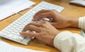 Closeup of a male hands busy typing on a keyboard computer. Royalty Free Stock Photo