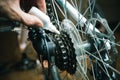 Closeup of male hands cleaning and oiling a bicycle chain and gear with oil spray. Working process Royalty Free Stock Photo