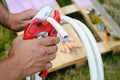 Closeup of male hands cutting metal-plastic pipe