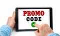 Closeup of a male hands holding tablet pc with text PROMO CODE Royalty Free Stock Photo
