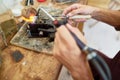Artisan Melting Metal in Workshop