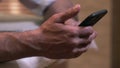 Closeup of Male Hands Scrolling Smartphone Screen